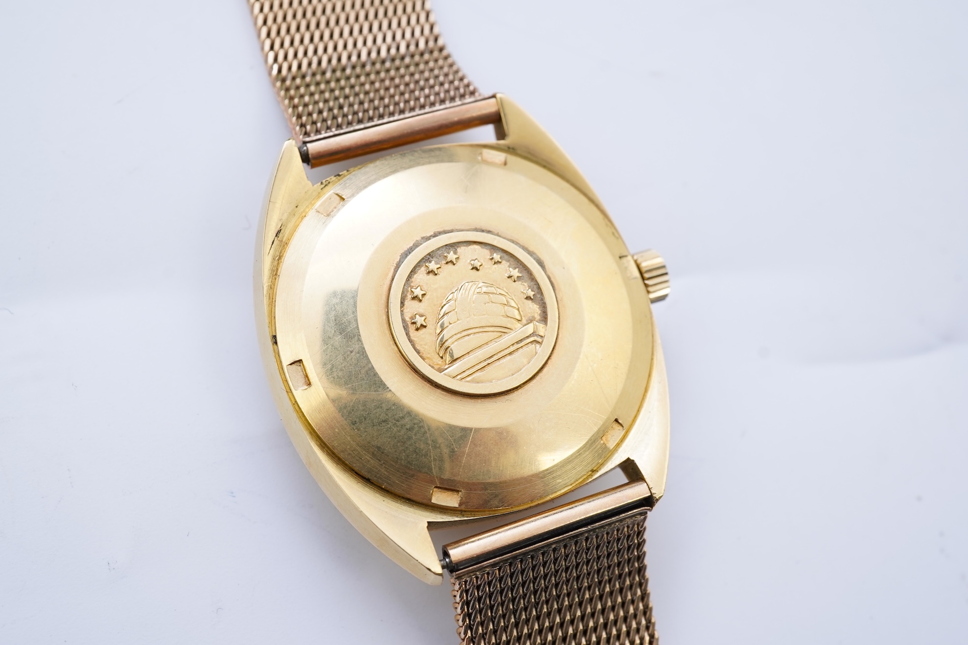 A gentleman's late 1960's 18ct gold Omega Constellation Automatic Chronometer Officially Certified wrist watch, on an associated 9ct gold mesh link bracelet